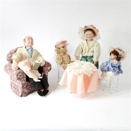 1995 Ashton-Drake "Only At Grandma's and Grandpa's Collection" Dolls: A set of vintage Ashton-Drake “Only at Grandma and Grandpa’s Collection” dolls. This porcelain collection from 1995 features a snoozing grandfather seated in an armchair, holding a book and a blonde grandchild on his lap, titled I’ll Finish the Story, Grandpa. Additionally, a grandmother, granddaughter, and plush teddy bear seated at a table and dressed for tea, titled And Teddy Makes Three. Each set comes with a certificate of authenticity.