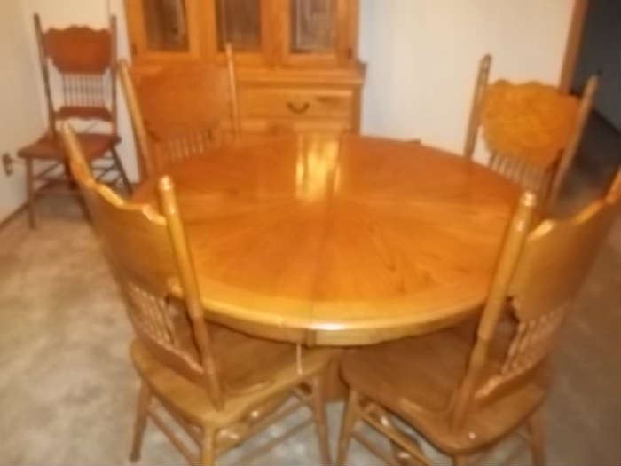 oak pedestal table and 7 chairs and 24 inch leaf $450