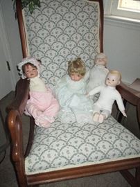 More dolls sitting in a Rosewood Rocker