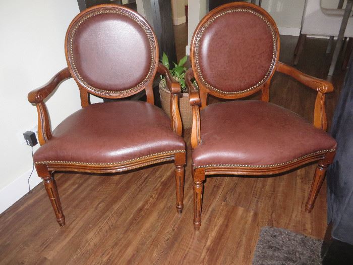2 wood Arm Chairs with leather seats, grommet accents