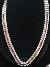 White gold and multi stone necklace ( sapphires, topaz,diamonds ) with matching earrings. Sold as a set .Reg. $5800. Sale  $2900.