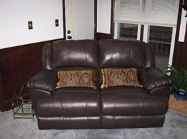 Leather reclining love seat. Everything in this house is in like new condition