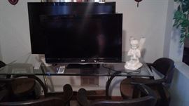 flat screen TVs, glass top table, angels