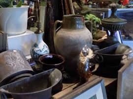 Pair of French wall fonts (left and right). Earthenware jug in center
