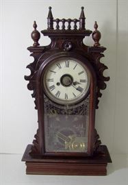Clock #12 C/1880 Walnut Victorian Welch Gingerbread clock w/alarm, Oak leaf pendulum, 23" h.