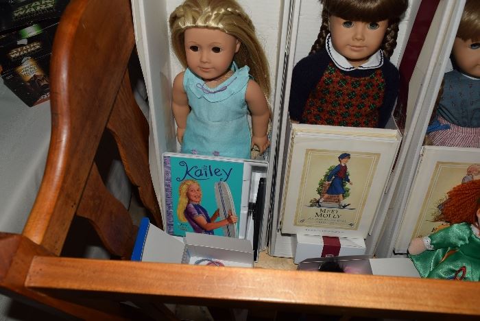 4 American Girl dolls with boxes