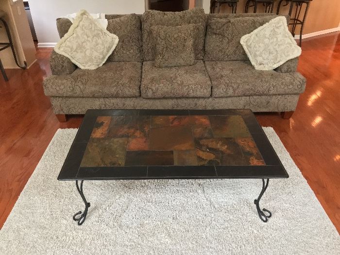 large sofa, area rug, slate coffee table 
