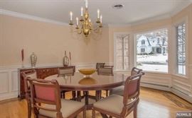 Trosby Furniture, Sussex, England Traditional fine quality dining room handmade in England, mahogany 60" round table with round extension leaves, 8 Regency chairs, buffet, pair of corner cabinets