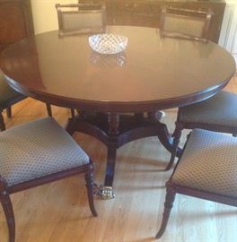 Fine made in England inlaid mahogany 60" round table with round extensions, 8 Regency chairs