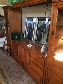 Large entertainment system for large TV, storage, & display; framed art of black Friesian horses