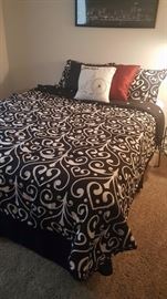 Queen size bed with bedding...very nice.