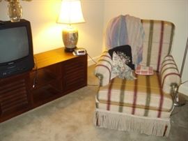 upholstered chair, table lamp