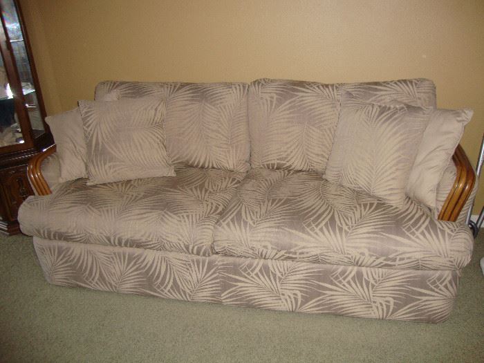 Cane sofa sleeper with palm design upholstery