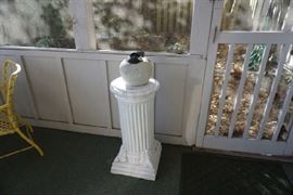 Pedestal with large bird sitting on top