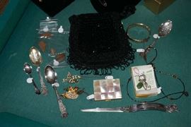 Letter opener, (center) American Beauty Compact,  Jade pin,  two other decorative pins