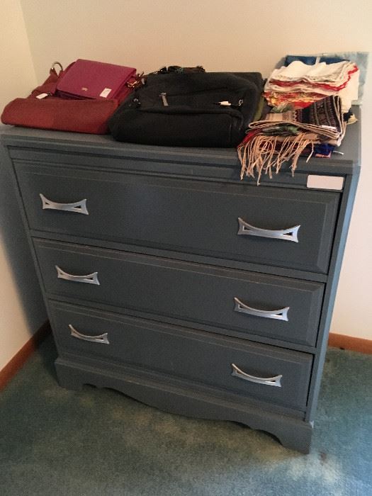 This is a nice three-drawer dresser in a nice blue hue.  Some nice purses and scarves as well.