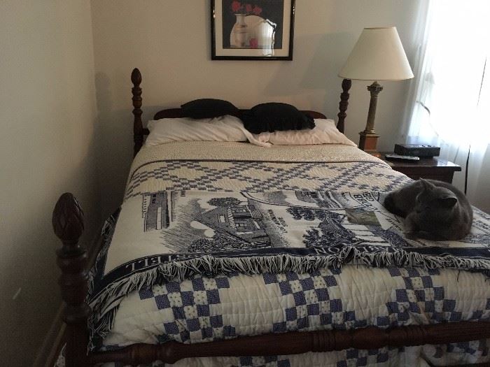 Mahogany bed frame and mattress set (cat not included).