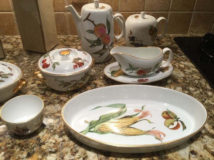 Set of 12 place settings of Royal Worchester Evesham pattern dinnerware: dinner, salad, bread plates, bowls, cups and saucers, also serving pieces: platter, tea pot, coffee pot, gravy boat and saucer, covered casserole dishes, au gratin baking dish, demitasse cups and saucers, etc. 