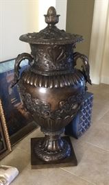 Statement piece: decorative bronze urn embellished with floral and leaves pattern, 2 handles, and finial, 4’4” H to top of finial, Small blue chest with 20 drawers and metal pulls for each drawer