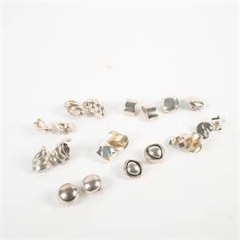 Sterling Silver Earring Collection Featuring Georg Jensen: A collection of ten pairs of vintage sterling silver earrings, including one pair by Georg Jensen. The earrings feature a variety of shapes and designs, with various maker’s marks. Some are not marked.
