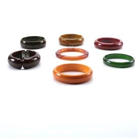 Costume Jewelry Collection Bakelite Bangle Bracelets: A collection of costume jewelry Bakelite bangle bracelets. This collection of eight Bakelite bangle bracelets are presented in orange, green black, red and brown.