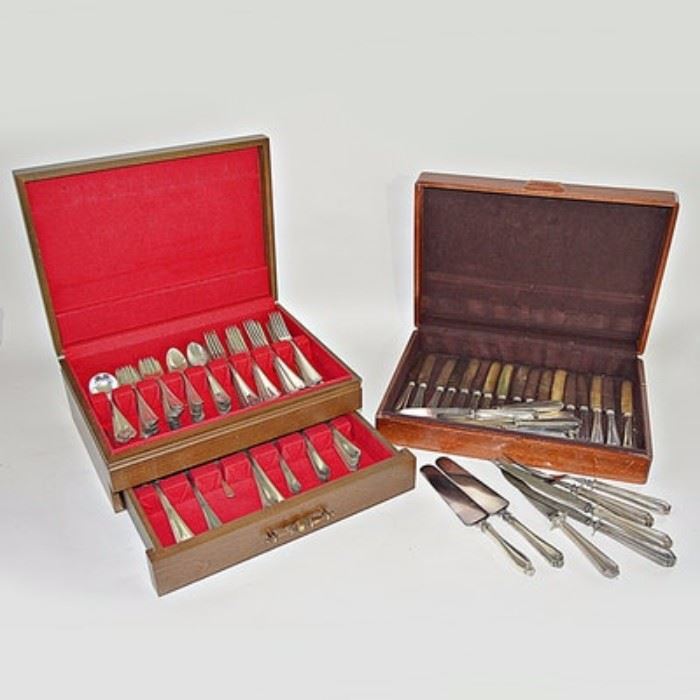 Large Set of Watson "Martha Washington" Sterling Silver Flatware, 199.78 Ozt.: A set of Watson Martha Washington sterling silver flatware. The pattern features a ribbed border and floral accent to the handle end. Each piece is marked Sterling to the verso. The set includes two cake servers, three serving knives, two serving forks, 30 dinner knives, one butter knife, 40 dinner forks, 56 teaspoons, 12 olive forks, one pierced spoon, 8 large spoons, 33 salad forks, two large serving spoons, ten ice teaspoons, one spreading knife, one gravy ladle, eight grapefruit spoons, three large bowl teaspoons, one sterling-handled meat fork (different pattern), twelve teaspoons, three soup spoons, twelve butter knives and 12 soup spoons. The set includes two wooden storage boxes. An additional monogrammed sterling silver-handled carving set is included. Total approximate weight exclusive of all knives with stainless steel blades is 199.78 ozt.