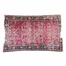 Antique Hand-Knotted Sarouk Wool Accent Rug: An antique hand-knotted Sarouk wool accent rug. The rug has an alizarin red background populated with mirrored floral vases and overall arabesque and foliate design in shades of blue gray, medium blue, off white, black and celadon green. The rug has a complex compound border with a dark major border in a flower and foliate pattern, flanked by a pair of blue gray guard stripes in a floral meander motif. The rug has off white warp fringe to both ends (damaged).