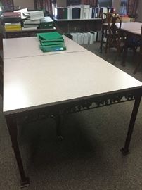 One of several wrought iron tables with formica tops