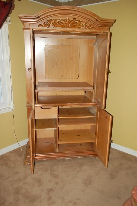 Oak entertainment center - opened to display cabinet and TV space