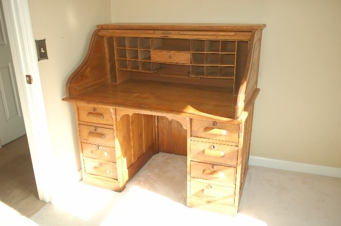 Antique roll top desk, top open displaying "cubby holes" and desk top