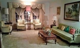 Gorgeous Formal Living Room scene of beautiful vintage 1950"s furniture and small collectible "art glass" on coffee table.  Beautiful original oil painting hanging over lovely mid-century  chartreuse green sofa. Absolutely magnificent "back-drop" of beautiful custom gold draperies.
