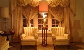 Beautiful enchanting "mid-night" lighting of 1950's Tower lady statue lamp resting on guilded gold-leaf twisted leg pedestal and anchored by paired vintage gold floral upholstered channel-back chairs.