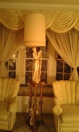 Beautiful close-up of lovely lamp nesting on guilded gold-leaf pedestal.