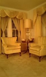 Single velvet upholstered yellow-gold channel-back chair and lovely round Duncan-Phyfe three-legged lamp table.