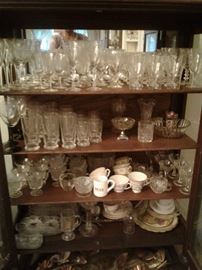 Lots of wonderful crystal glassware inside antique China Cabinet.