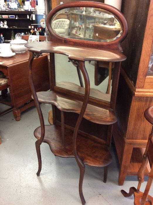 Beautiful cherry curio stand with beveled glass.