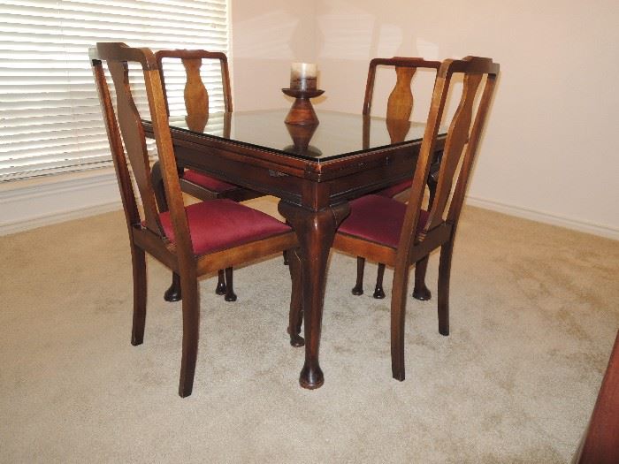 Antique Game table with pull out leaves.  4 chairs.  glass top