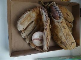 2 Old baseball mits & 2 balls.