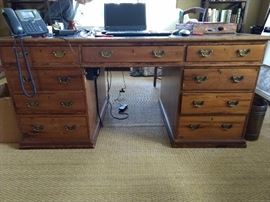 THIS! Now this is a desk! It's a ca. 1890 leather-topped PINE English partner's desk. The age has given it a lovely golden patina. The tooled leather top has been replaced and they did a fantastic job.                                                       Most partner's desks you see are mahogany or cherry, but this one is very handsome and begs to be taken home - with you! This handsome English thang measures 5' 6" L x 31" T x 3' D.