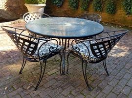Nice Woodard wrought iron patio table and four armchairs. 