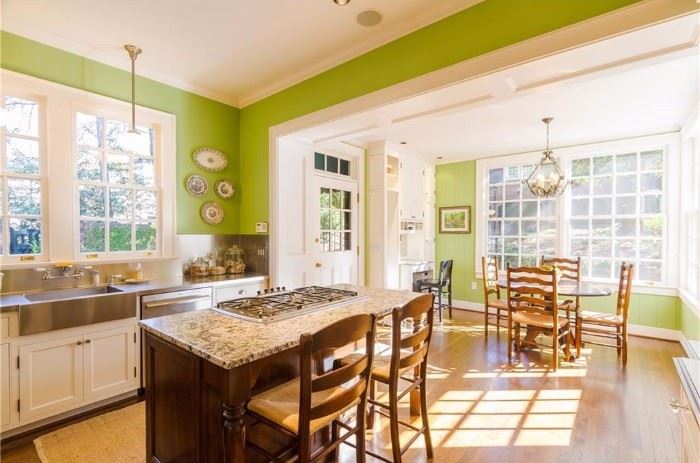 Love their kitchen! The two mahogany/rush barstools are available, as well as the round table and chairs in the distance.