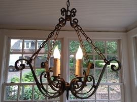 Ooooh , yummy! A vintage, wrought iron chandelier. Don't go yankin' on all the lighting in this house, we have professional "hep" to remove these beauties, so they can light up your dim world.  