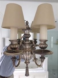 A single wall sconce, hung on a mirror, so that objects will appear larger. Just don't ask if the wall sconce makes you look fat. Please.
