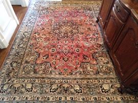 Vintage Persian Kashan, signed by the weaver, with muted colors, hand woven, 100% wool pile, measures 8' 4" x 11' 7".