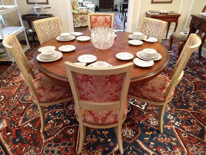 Set of 6 French Louis XVI dining room chairs, 4 sides & 2 arms, round Drexel inlaid wood dining table, atop the huge Persian Bahktiari rug. The table is set with four place settings of the Herend "Coronation" china.