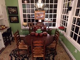 Breakfast room, all dolled up, with original oil paintings, hand woven Persian design rug, vintage Mexican pottery, Tiffany style stained glass table lamps, vintage wire tater bins and more!
