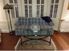 Not too offensive plaid sofa, by Hickory Chair, with nice wrought iron/beveled glass coffee table and complimentary color hand woven Persian rug.                          Just snuggle next to your honey bunny on this thing and have sexy kwaffee tawk!