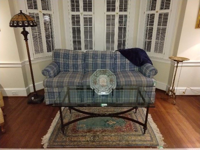 Not too offensive plaid sofa, by Hickory Chair, with nice wrought iron/beveled glass coffee table and complimentary color hand woven Persian rug. Just snuggle next to your honey bunny on this thing and have sexy kwaffee tawk!