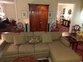 Nice, two-piece sectional, with spider-backed mahogany armchairs by Hekman Furniture Co., High Point, NC,  pair of green marble pedestals, with antique French armoire anchoring the room. 