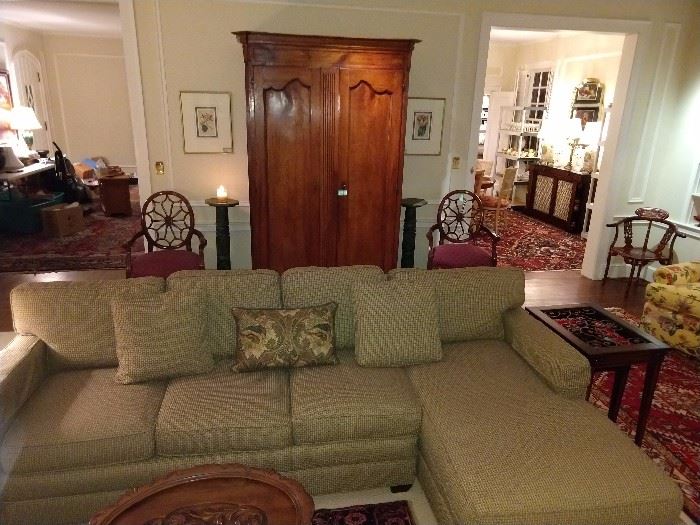 Nice, two-piece sectional, with spider-backed mahogany armchairs by Hekman Furniture Co., High Point, NC, pair of green marble pedestals, with antique French armoire anchoring the room.
